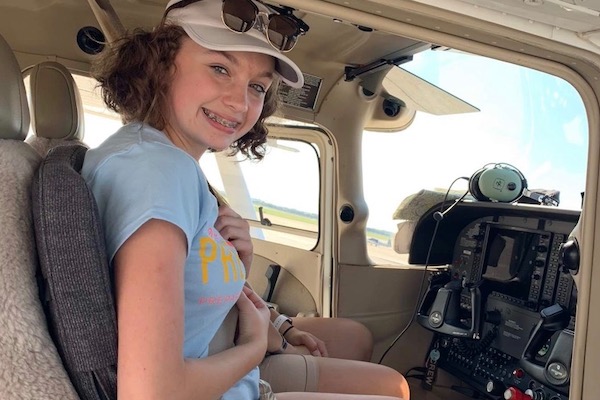flight deck; girls at controls; girl with headset; learning to fly; girl smiling; girl with confidence; girl; cessna 172